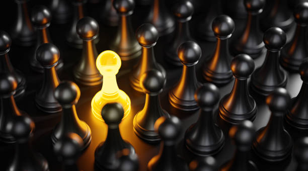 istock Standout Concept Yellow Glow Pawn Chess Between Black Pawns 3D Render 1419023672