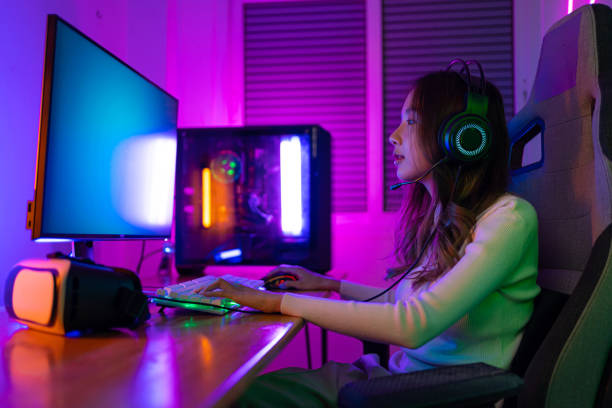 istock Asian gamer playing online video game winning excited on PC with lighting effect, broadcast streaming live at home. Gamer and E-Sport online gaming technology Championship tournament gamer concept. 1419024255