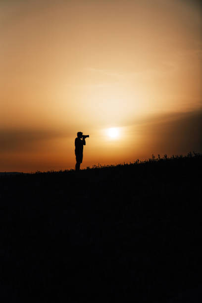 istock Silhouette of a photographer at sunset 1419024744