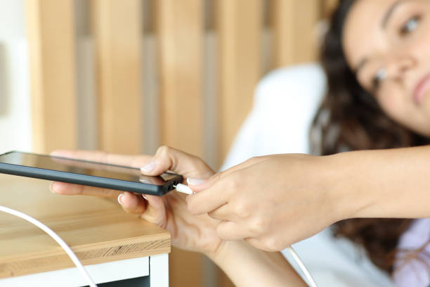 istock Woman connecting usb charger on smart phone 1419025836