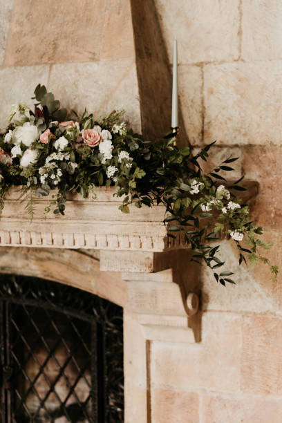 istock A beutiful flower decoration on top of a sandstone fireplace lintel. Copy space. Wedding interior decoration concept. 1419027058