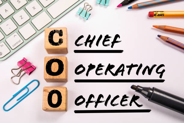 istock COO - Chief Operating Officer. Computer keyboard and office supplies on a white background 1419027739