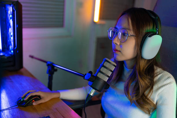 istock Asian gamer playing online video game winning excited on PC with lighting effect, broadcast streaming live at home. Gamer and E-Sport online gaming technology Championship tournament gamer concept. 1419028463