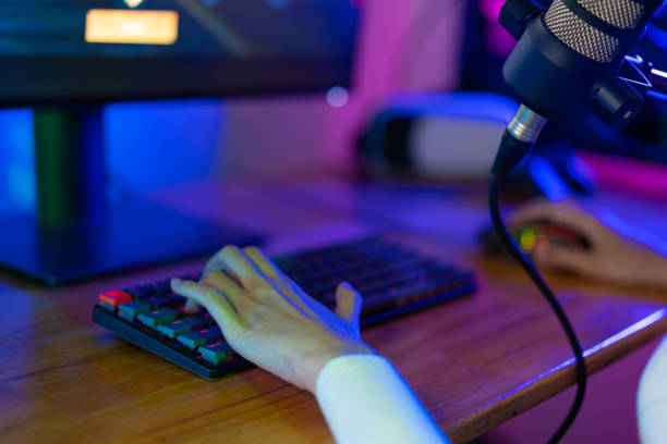 istock Asian gamer playing online video game winning excited on PC with lighting effect, broadcast streaming live at home. Gamer and E-Sport online gaming technology Championship tournament gamer concept. 1419028850