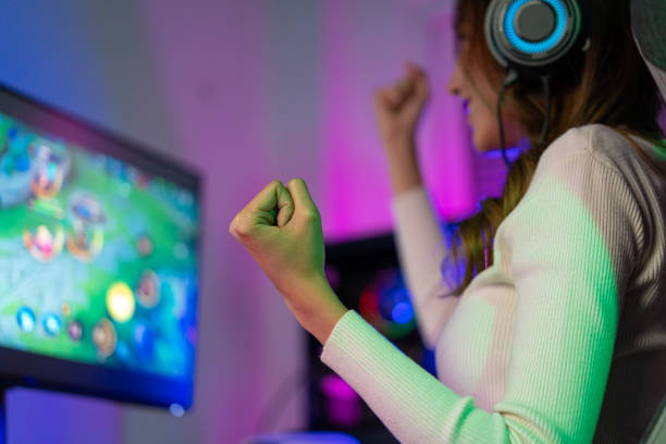 istock Asian gamer playing online video game winning excited on PC with lighting effect, broadcast streaming live at home. Gamer and E-Sport online gaming technology Championship tournament gamer concept. 1419030865