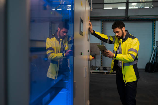 istock Young industrial worker operating cnc machine at metal machining industry 1419032644