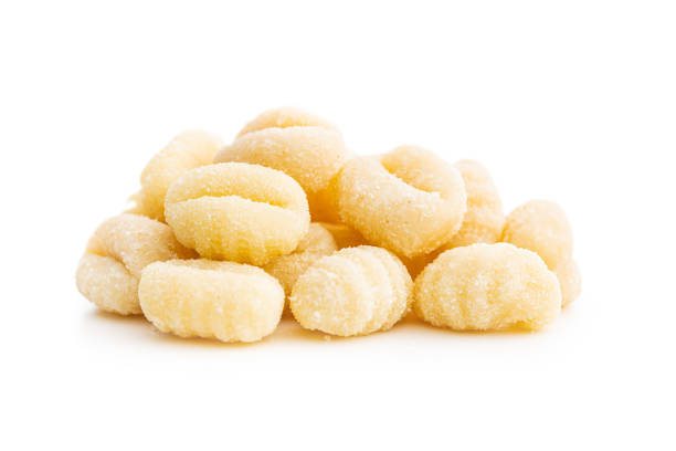 istock Uncooked potato gnocchi isolated on white background. 1419033575
