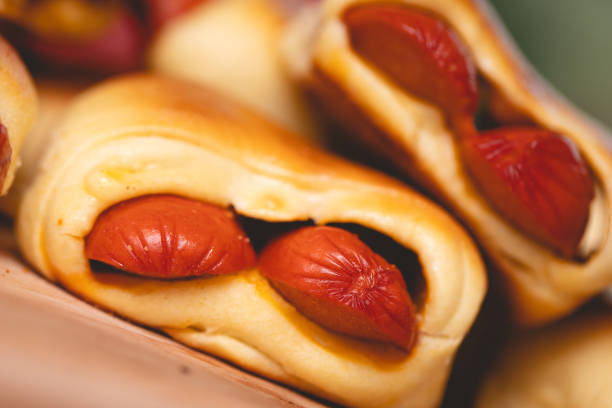 Hot dog baked with bread dough (Syrian hot dog) or sausage roll in bread dough. Traditional salted in Brazil. Brazilian food. Hot dog. Hot dog baked with bread dough (Syrian hot dog) or sausage roll in bread dough. Traditional salted in Brazil. Brazilian food. Hot dog. savory stock pictures, royalty-free photos & images