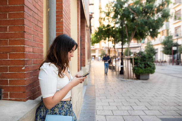 istock Young woman in a city using a smart phone 1419035445
