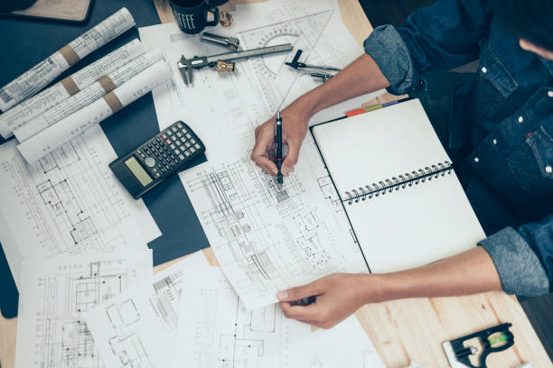 istock Architect engineer use pen  drawing design working on blueprint. House planning design and construction concept. 1419035731