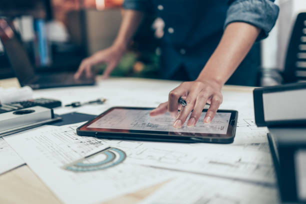 istock Architect engineer use tablet to read drawing design. House planning design and construction concept. 1419035778