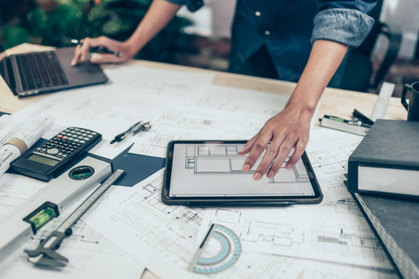 istock Architect engineer use tablet to read drawing design. House planning design and construction concept. 1419035812