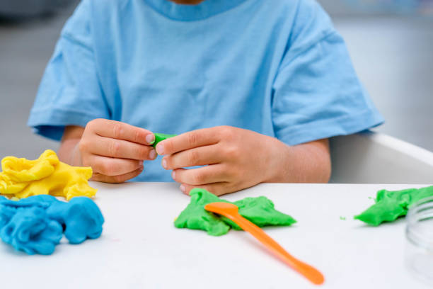 istock Caucasian boy plays with plasticine on table, modeling clay, molds, sculpture. 1419036123
