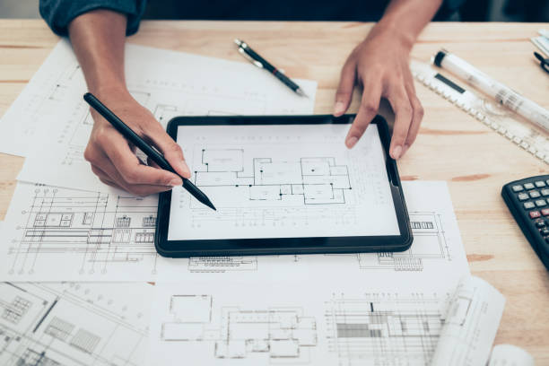 istock Architect engineer use tablet to read drawing design. House planning design and construction concept. 1419036327