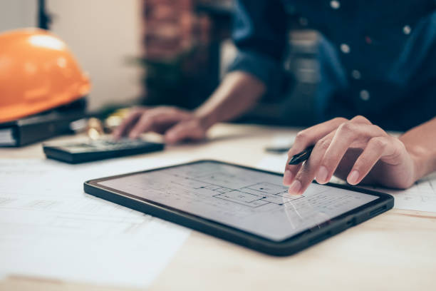 istock Architect engineer use tablet to read drawing design. House planning design and construction concept. 1419036386