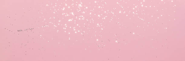 istock Sparkling silver glitter on pink background banner 1419039854