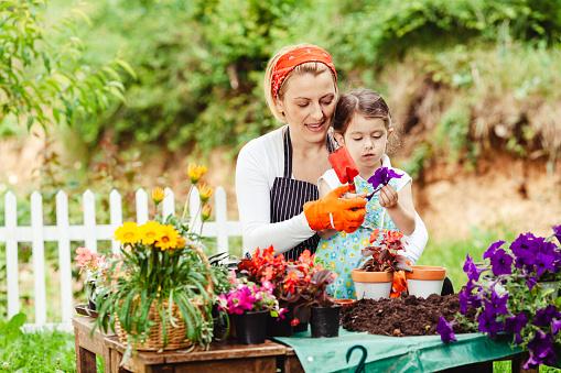 Mother and daughter gardening together in the yard