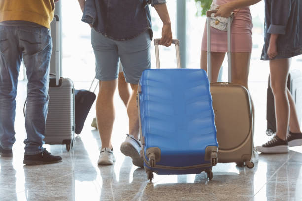 istock Passengers walking with luggage at airport 1419043724