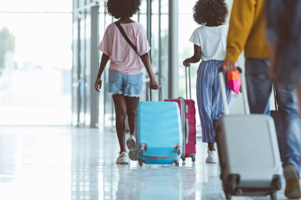 istock Passengers walking with luggage at airport 1419044009