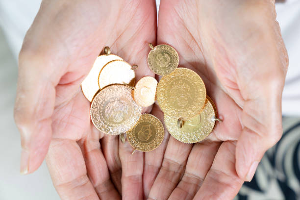 istock Hand holding Turkish gold coin, Close up 1419044015