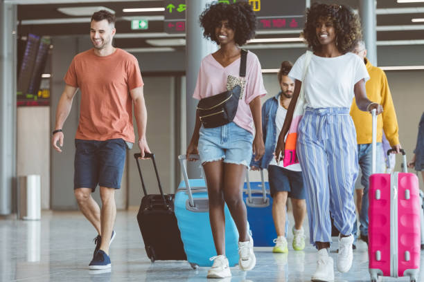 istock Passengers walking with luggage at airport 1419044260
