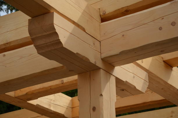 istock a carpenter built a log cabin with rough hewn beams. wood planing was not done before. authentic craftsmanship wooden log cabin. mortises for placing roof beams. gouging wood, ax, cut 1419044435