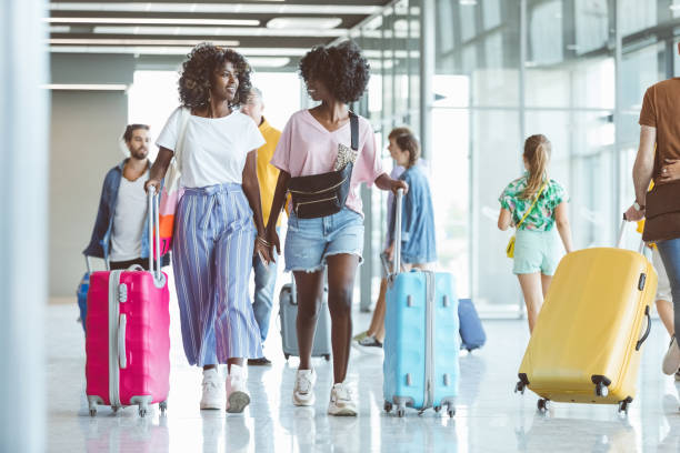 istock Passengers walking with luggage at airport 1419044464