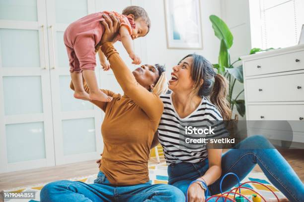 Gay Couple With Baby At Home Stock Photo - Download Image Now - Lesbian, Couple - Relationship, Baby - Human Age