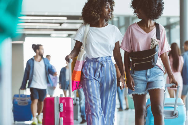 istock Passengers walking with luggage at airport 1419045725
