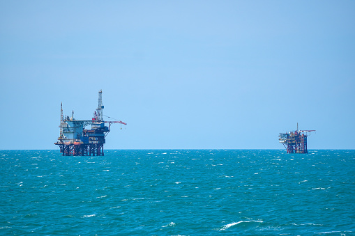 Oil or gas drilling platforms at sea.