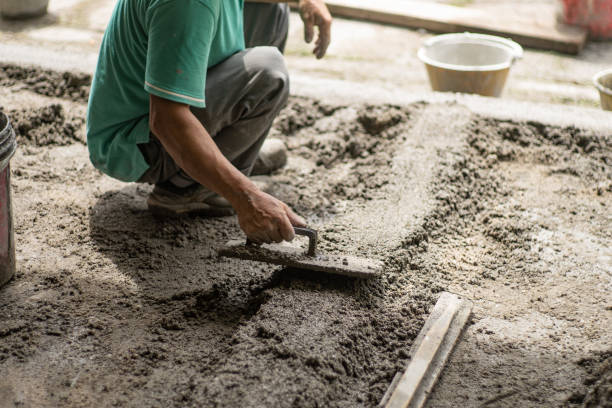 Close up Asian  worker laying down  smooth cement on work site stock photo
