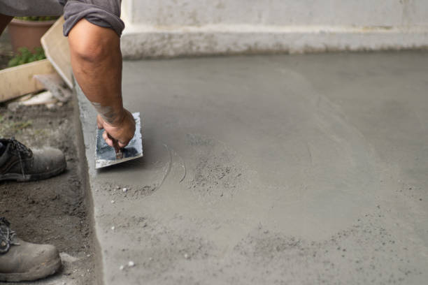 Close up Asian  worker smooth cement on work site stock photo