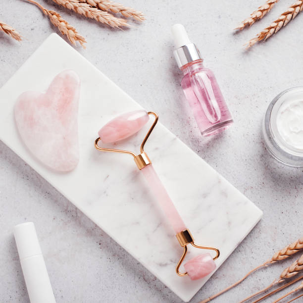 istock Facial roller, gua sha, serum and moisturizing cream on marble background 1419057195
