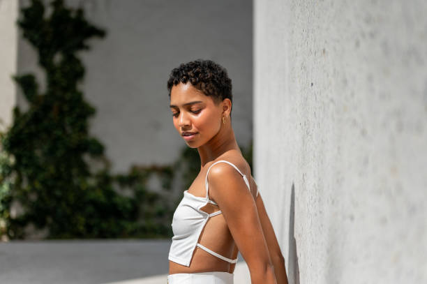 istock Beautiful young woman posing by the concrete wall 1419057212