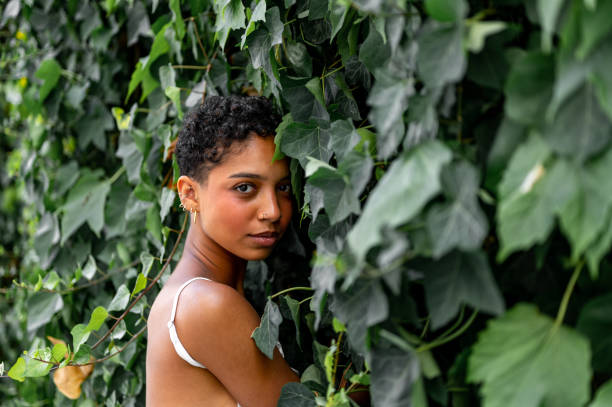 istock Beautiful young girl posing by the hedge 1419057421