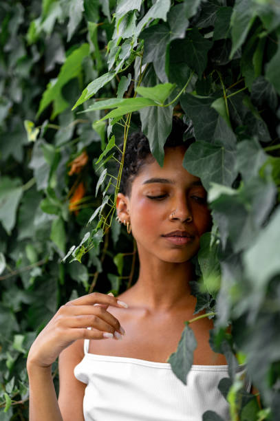 istock Beautiful young girl posing by the hedge 1419057550
