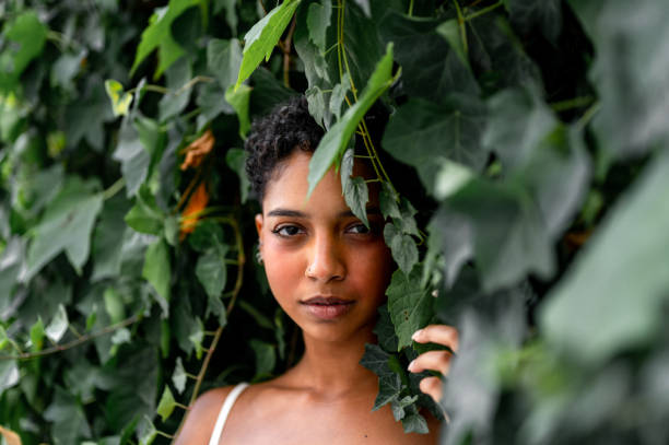 istock Beautiful young girl posing by the hedge 1419057595