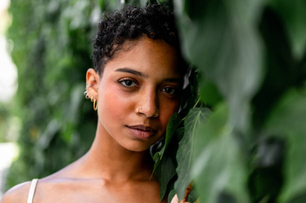 istock Beautiful young girl posing by the hedge 1419057618