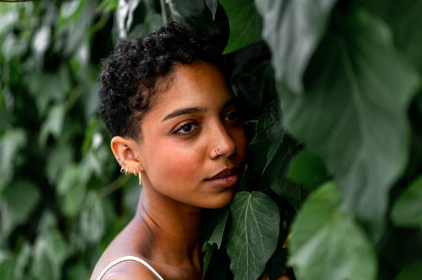 istock Beautiful young girl posing by the hedge 1419057634