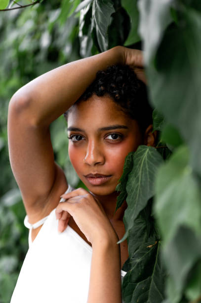 istock Beautiful young girl posing by the hedge 1419057696