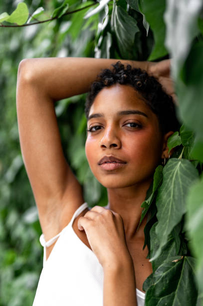 istock Beautiful young girl posing by the hedge 1419057702