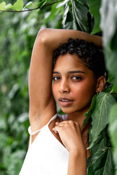 istock Beautiful young girl posing by the hedge 1419057705