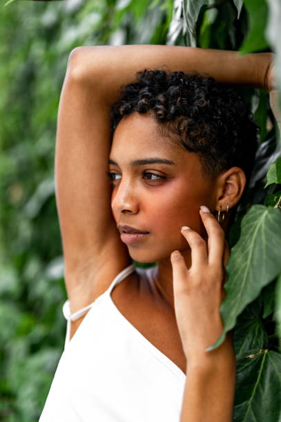 istock Beautiful young girl posing by the hedge 1419057757