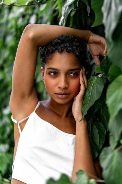 istock Beautiful young girl posing by the hedge 1419057773