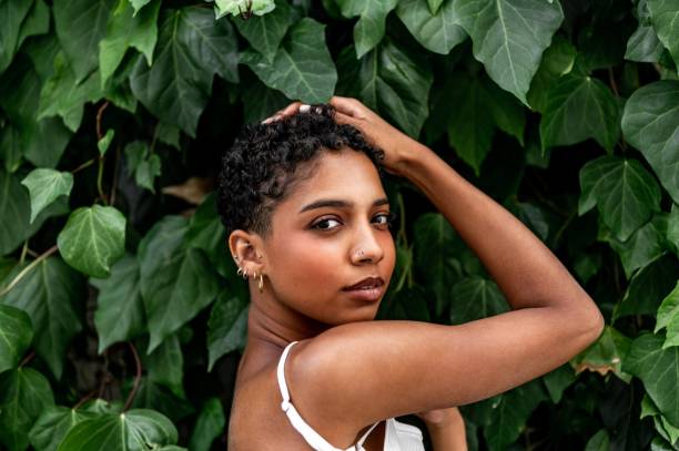 istock Beautiful young girl posing by the hedge 1419057797