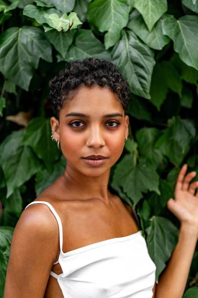 istock Beautiful young girl posing by the hedge 1419057812