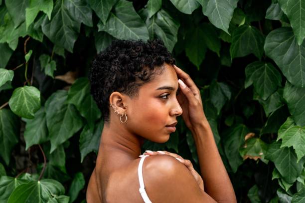 istock Beautiful young girl posing by the hedge 1419057813