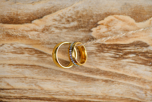 Classic golden wedding rings on the wooden background