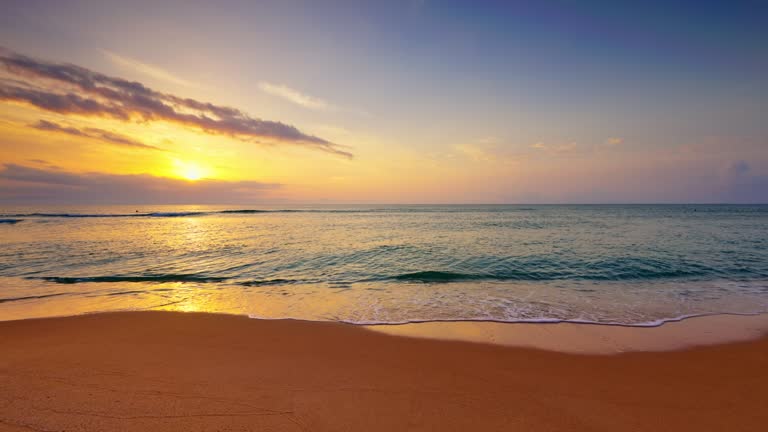 Ocean beach sunrise with color sky clouds and sun rays over sea waves, 4k video of nature landscape