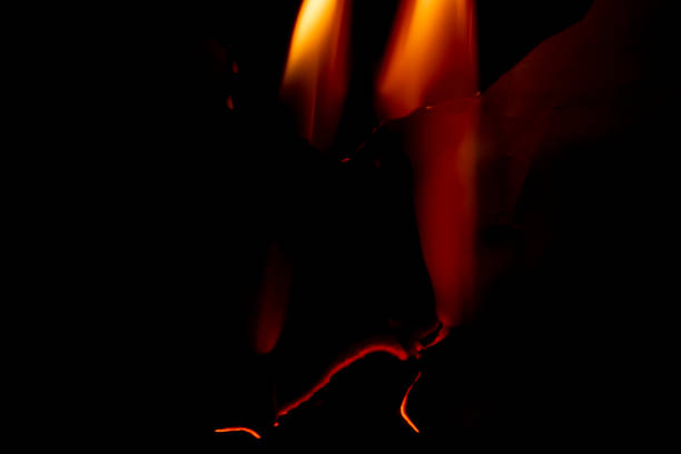 burning paper, glowing edge of paper on a black background burning paper, glowing edge of paper on a black background at the edge of burnt frame grunge stock pictures, royalty-free photos & images